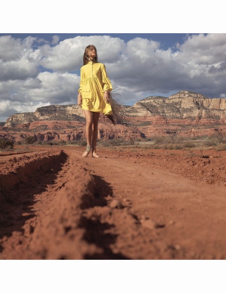 walking-down-a-red-dirt-road-in-the-arizona-desert-wearing-a-short-yellow-russian-throat-banded-shirt-dress-by-gayle-kirkpatrick-and-gold-foot-chain-wrapped-on-her-ankle-by-sant-angelo-vogue-1968