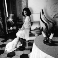 Marisa Berenson sitting on armchair wearing a Valentino skirt March 1968